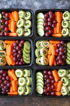 four trays filled with different types of vegetables and veggies in each container