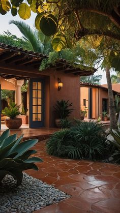 an outdoor patio with potted plants and stone walkway leading to the front door area