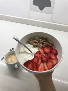 a bowl of strawberries, cashews and yogurt