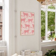 a living room with white walls and pink art on the wall