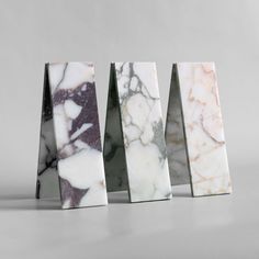 three pieces of marble sitting next to each other