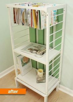 a white shelf with magazines on it next to a green wall and a wooden floor