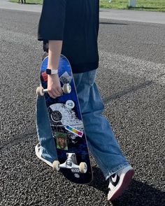 a person is walking with their skateboard on the street