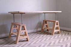 two wooden stools sitting next to each other on top of a carpeted floor