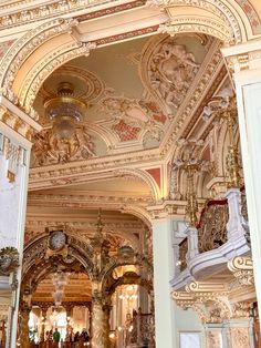 an ornately decorated room with chandeliers and paintings