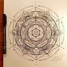 a pen drawing of an intricate design on paper