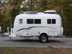 an rv parked in front of some trees