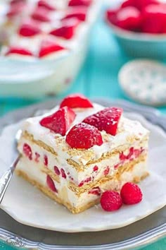 a piece of cake on a plate with raspberries