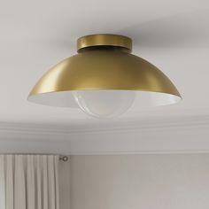 a light that is hanging from the ceiling in a room with white walls and curtains