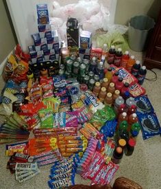 a pile of snacks and condiments on the floor