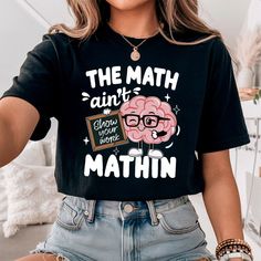 a woman wearing a black shirt with the words, the math isn't what you think