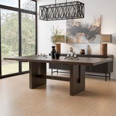 a dining room table with two vases on it and an art piece in the background