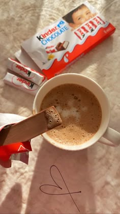 a cup of hot chocolate next to some candy bars