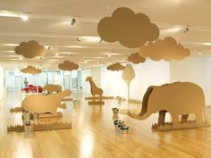 an art gallery filled with sculptures of animals and clouds