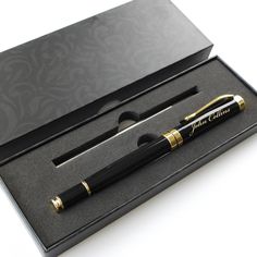 a black and gold pen in a box with its lid open to show the writing