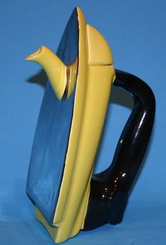 a blue and yellow coffee mug with a banana sticking out of it's side