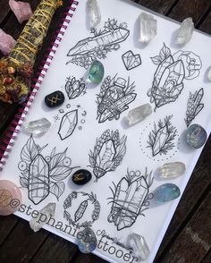 a notebook covered in lots of different types of crystals