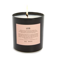 a candle with a label on it sitting in front of a white background that says les