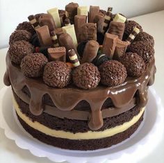 a chocolate cake topped with lots of different types of candies on top of it