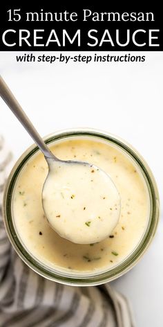 a spoon with cream sauce in it on top of a bowl