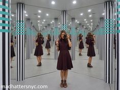 a woman standing in front of a mirror taking a selfie