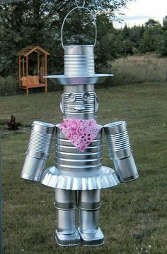 a tin can robot holding a pink heart