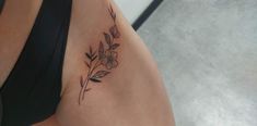 a close up of a woman's thigh with flowers on it