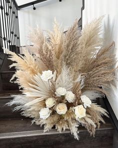 a bouquet of flowers sitting on top of a set of stairs