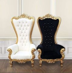 two black and white chairs sitting next to each other on top of a hard wood floor