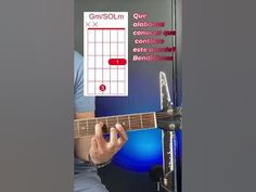 a man playing an acoustic guitar in front of a microphone and sound board with the words,