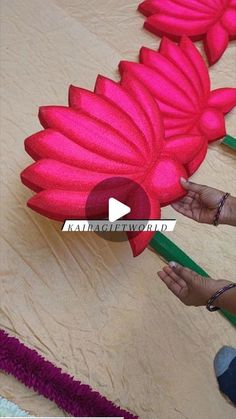 someone is making a flower out of yarn