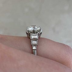 a woman's hand with a diamond ring on it