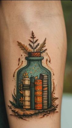 a tattoo with books in a jar on the leg