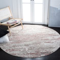 a round rug in a living room with a chair