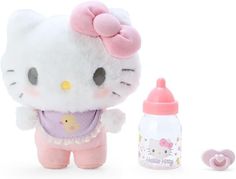 a hello kitty doll next to a baby bottle