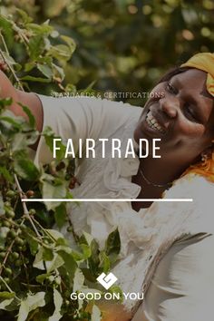 a woman picking berries from a tree with the words fair trade on it