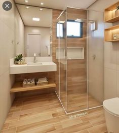 a bathroom with a toilet, sink and shower in it's center area is shown