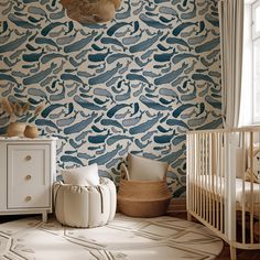 a baby's room with blue and white wallpaper