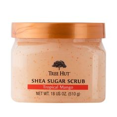 a jar of tree hutt shea sugar scrub on a white background with an orange lid