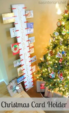 a christmas card holder is next to a tree with presents on it and the words, christmas