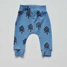 a pair of blue pants with black arrows printed on the bottom, and one leg