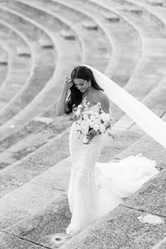 a woman in a wedding dress holding a bouquet