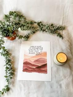 a candle and some plants on a bed with a card that says, there is nothing i have ever seen