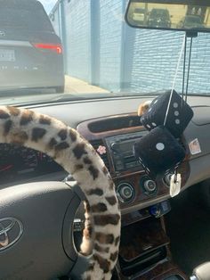 a car dashboard with a steering wheel covered in animal print and fuzzy plush materials