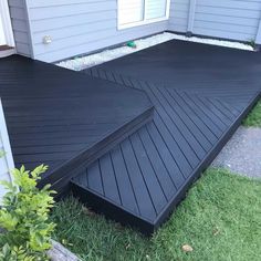 a black deck in front of a house