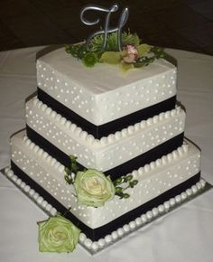 three tiered wedding cake with flowers on top