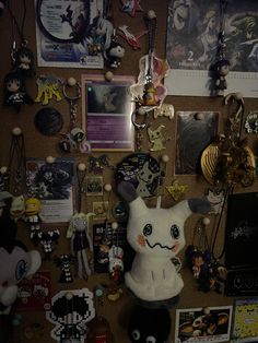 a wall covered in lots of assorted items and magnets on top of it