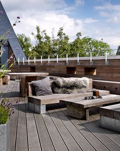 a wooden bench sitting on top of a wooden deck