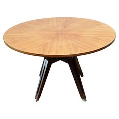 a round wooden table with two black legs