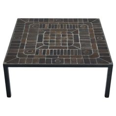 a square table with brown and black tiles on it